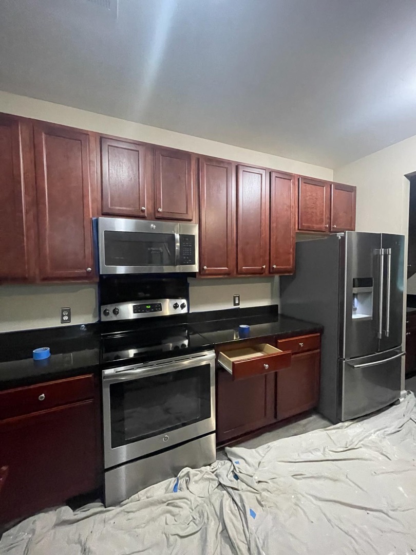 Dark cherry kitchen cabinets before painting