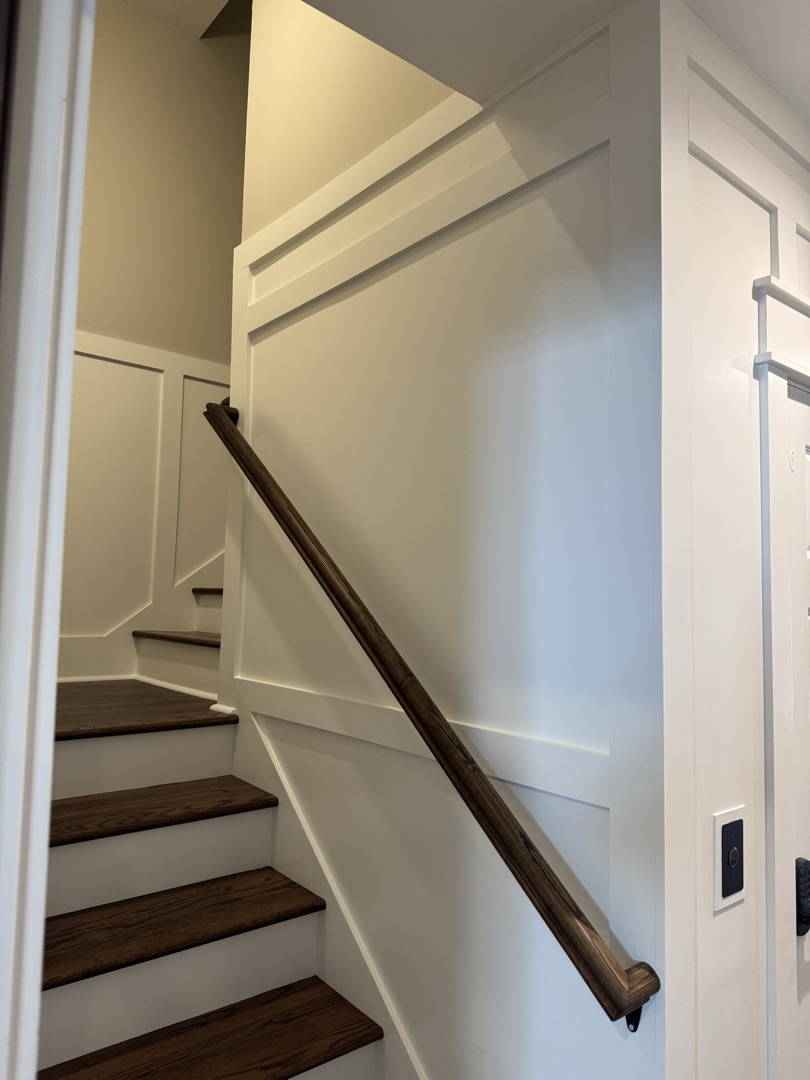 Stained handrail with wainscoting detail